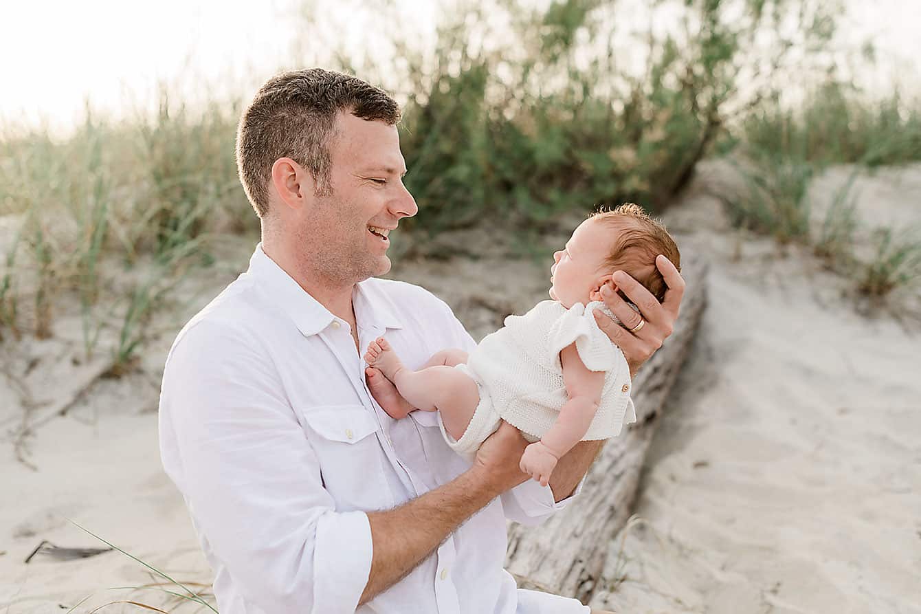 a father and his baby daughter at the beach, captured by destin florida family photographers