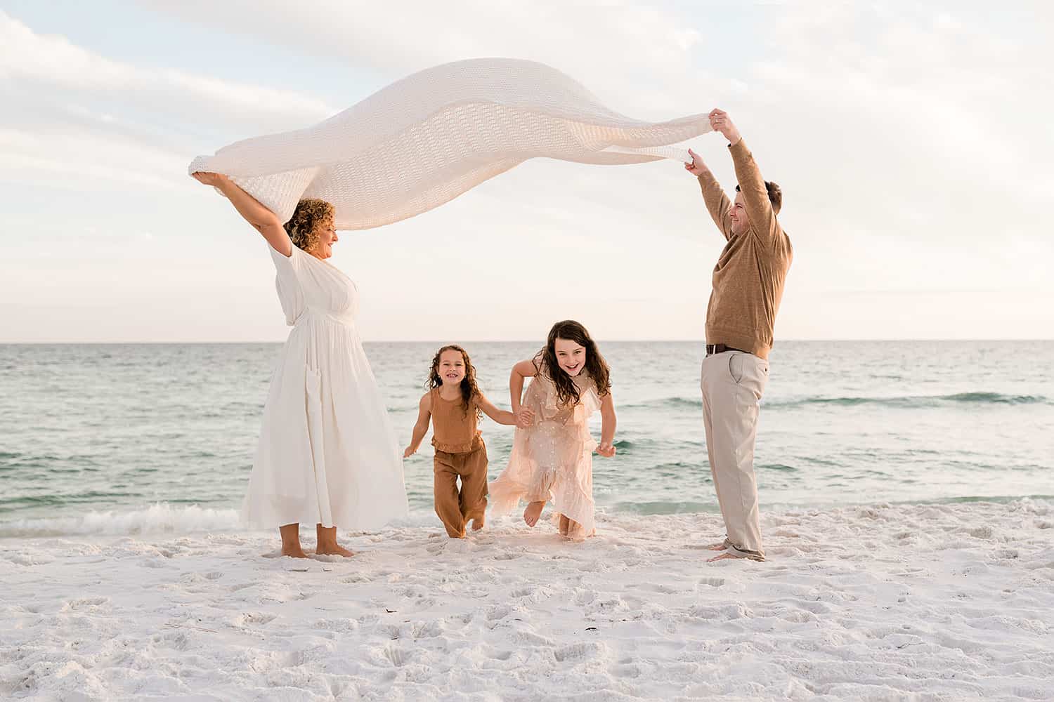 A family playing at the beach by Andrea Krey, one of Destin Florida beach photographers