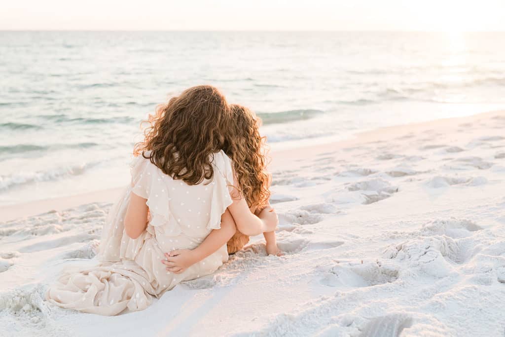 Two girl sitting by the water, by Andrea Krey, one of Destin Florida photographers