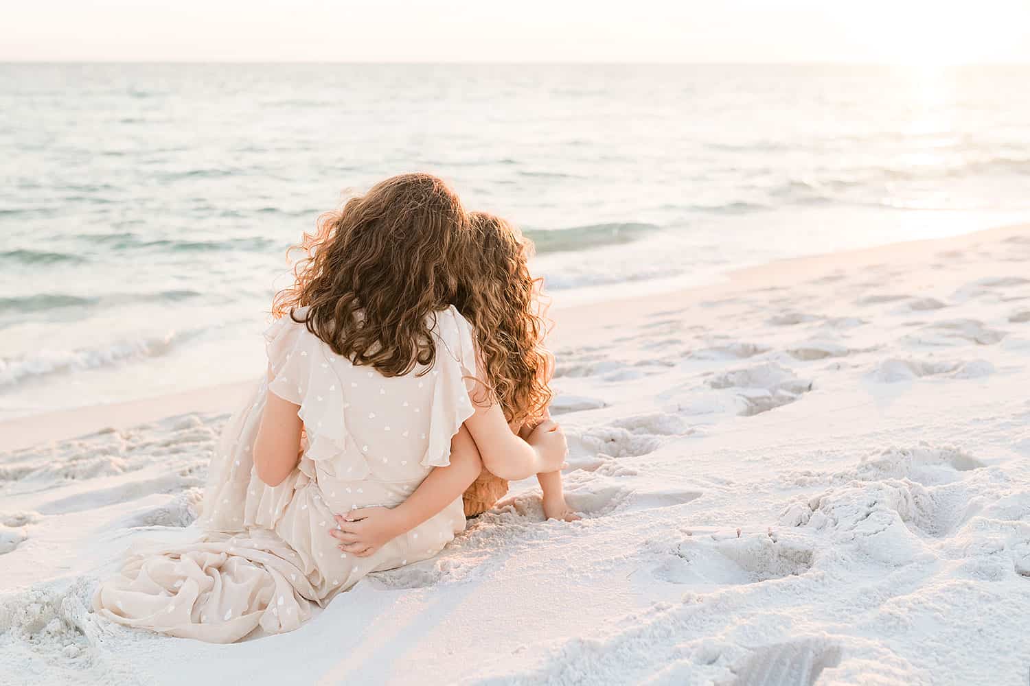 Two girl sitting by the water, by Andrea Krey, one of Destin Florida beach photographers