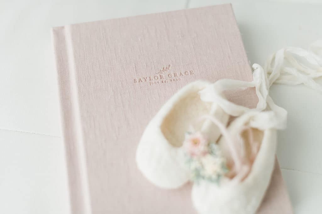 heirloom photo album with baby shoes - family photography keepsake