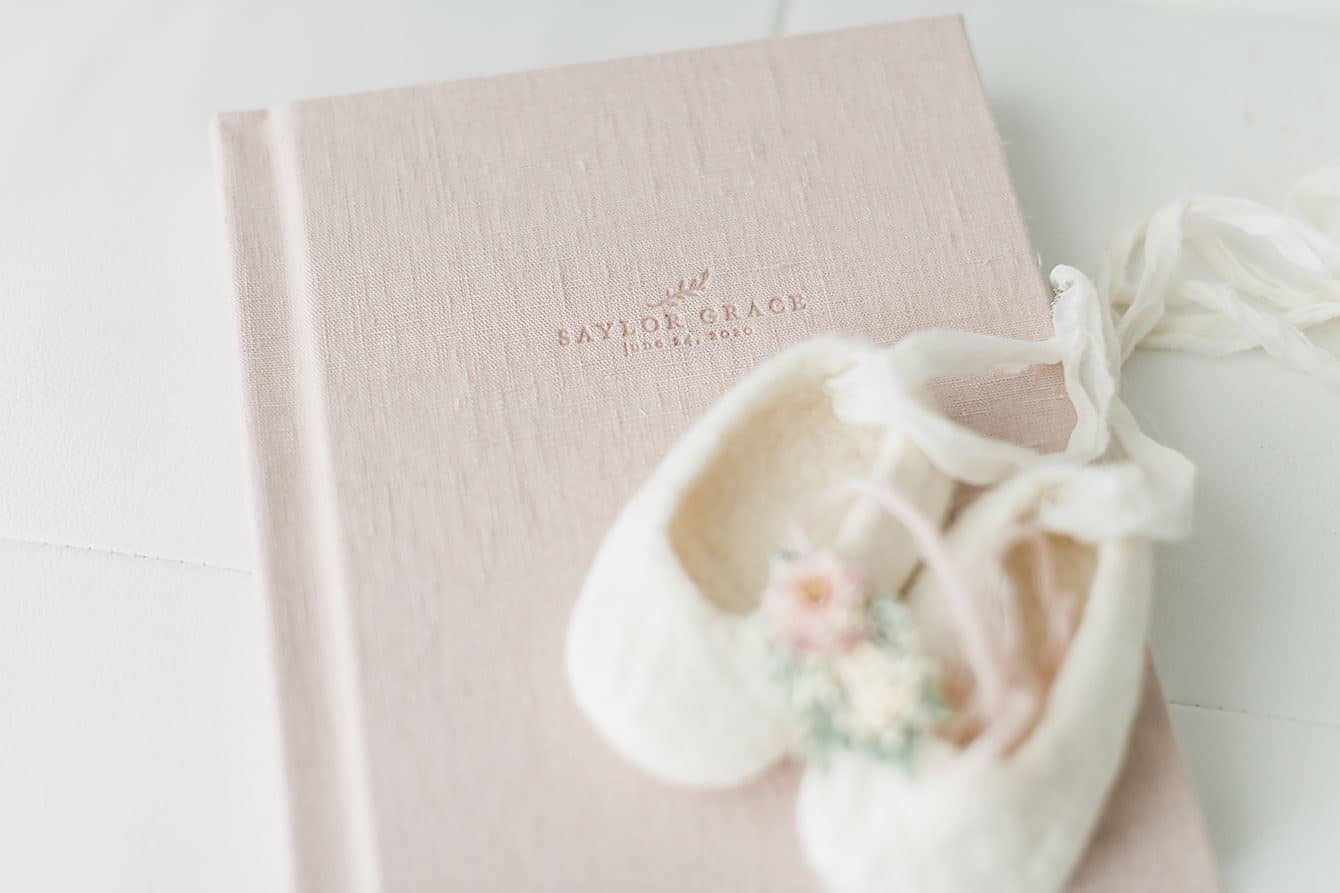 baby ballerina shoes decorating an heirloom album