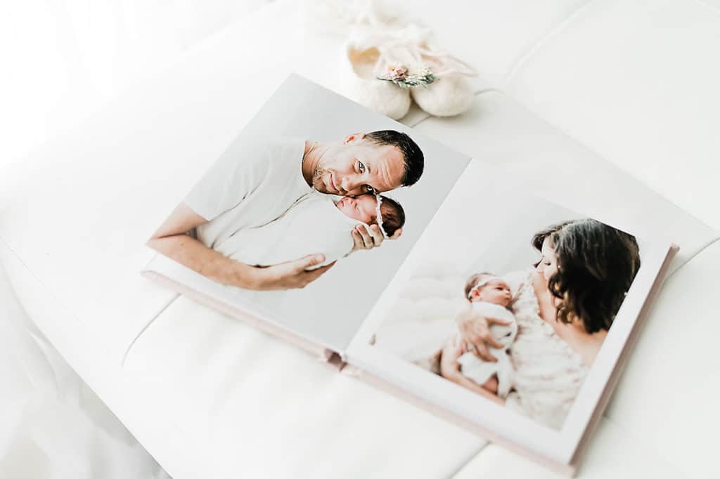 a mother and a father with their new baby in an album
