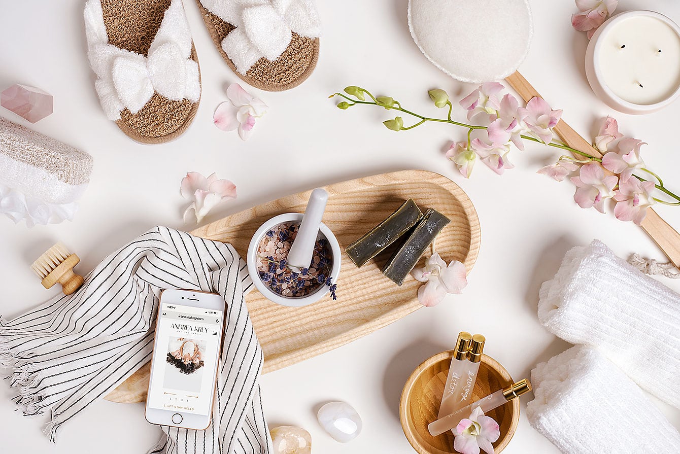 A flat lay of spa items evokes the relaxation of the best massage Destin FL on a striped cloth.