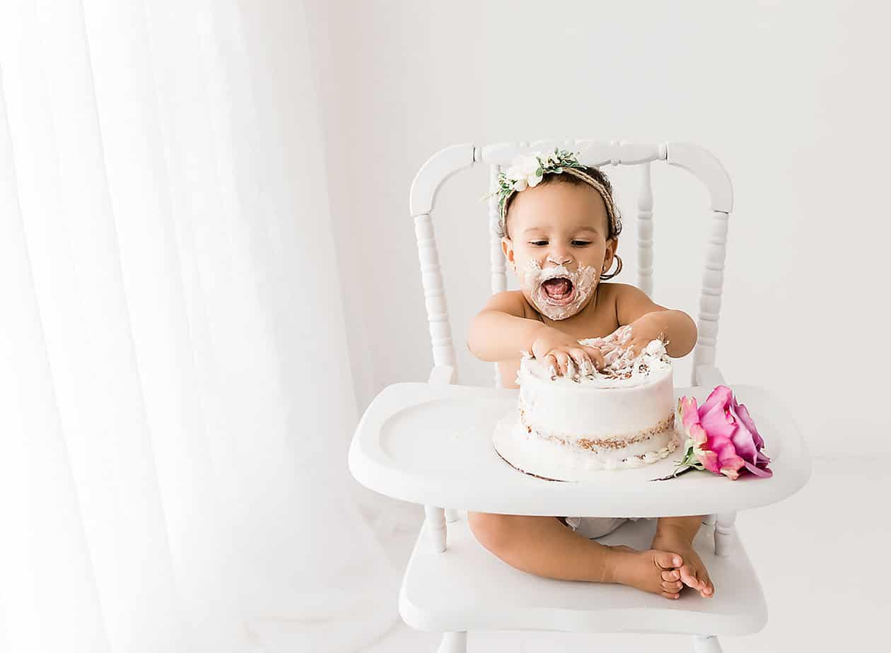 smiling baby eating cake at angelfish babysitting