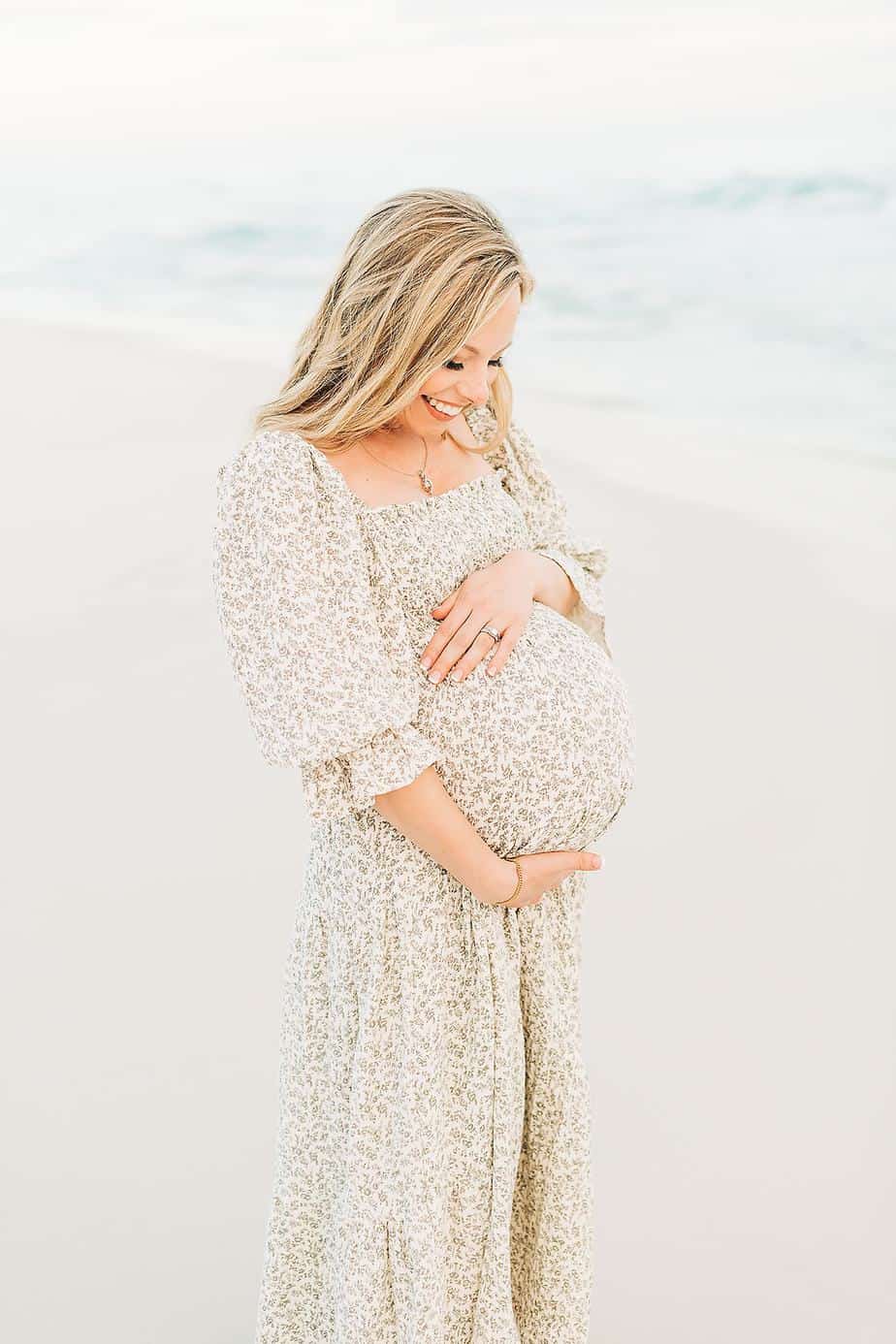 beautiful pregnant woman awaiting her newborn baby at the beach