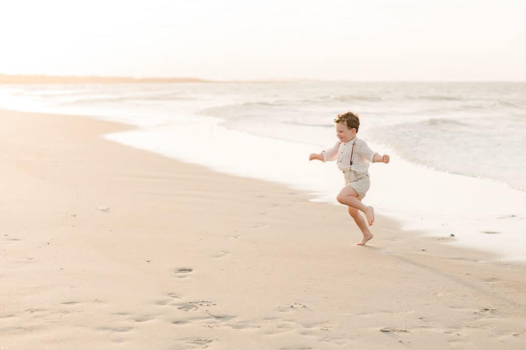 happy boy jumping on beach location