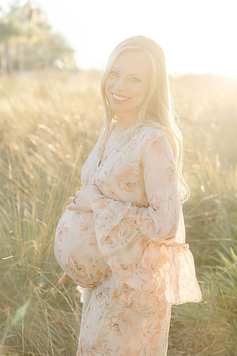 beautiful pregnant mother in a field at Fort Walton Beach