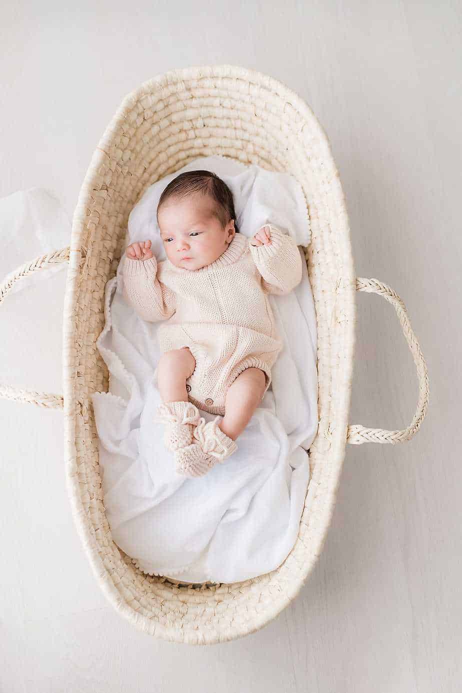 a newborn baby in a moses basket