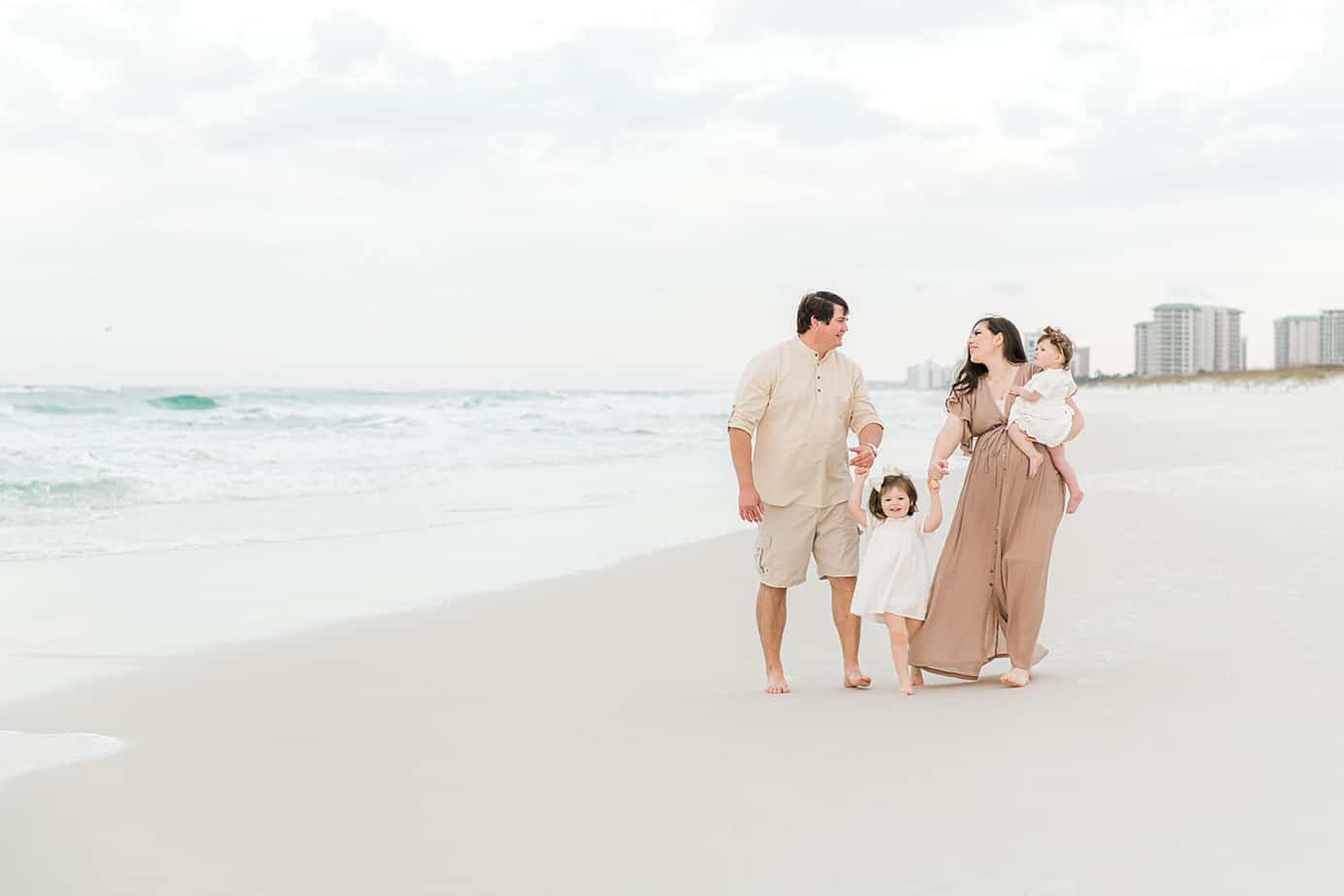 happy family walking at Grayton Beach with their photographers