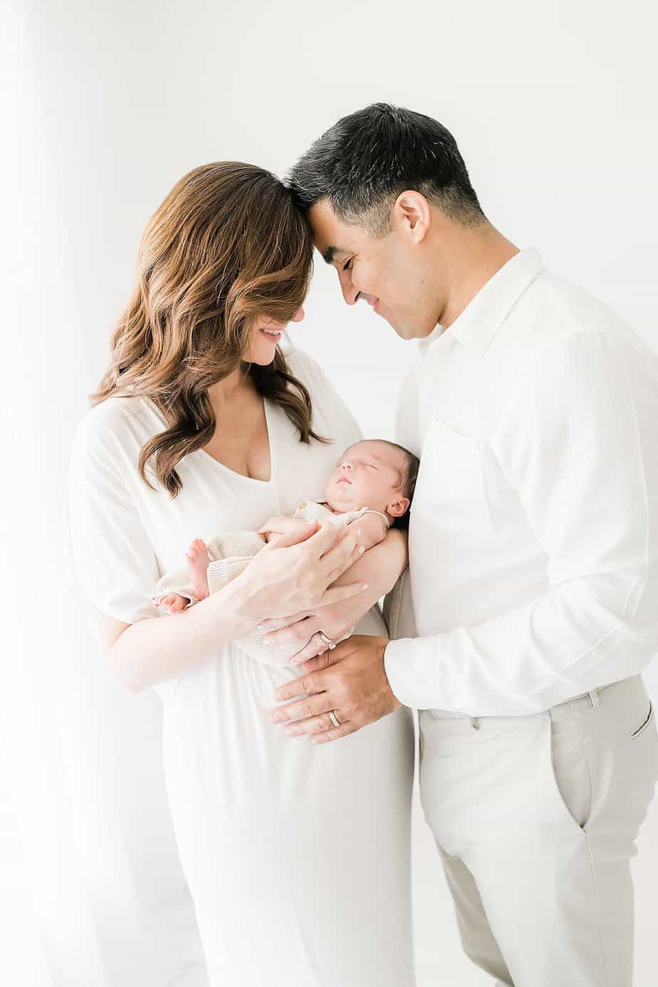 new parents being photographed in a studio by 30a newborn photographer