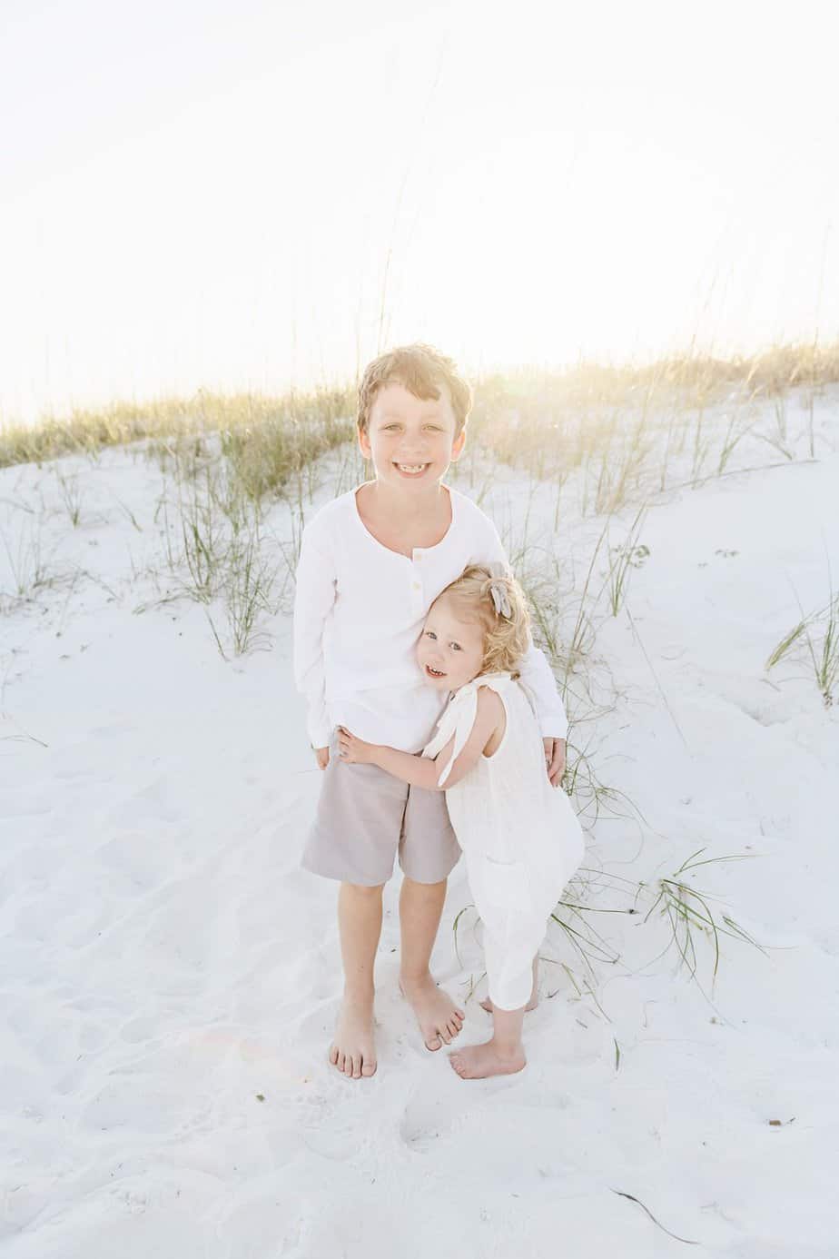 siblings holding each other with fort walton photography