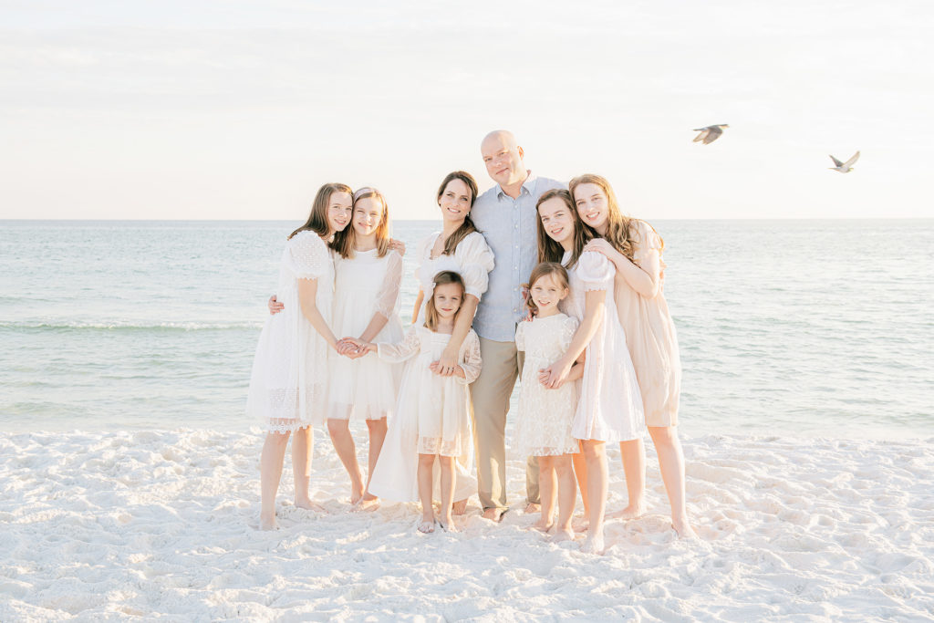 pretty family posing on a beach