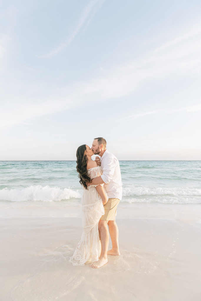 a couple kissing on the beach