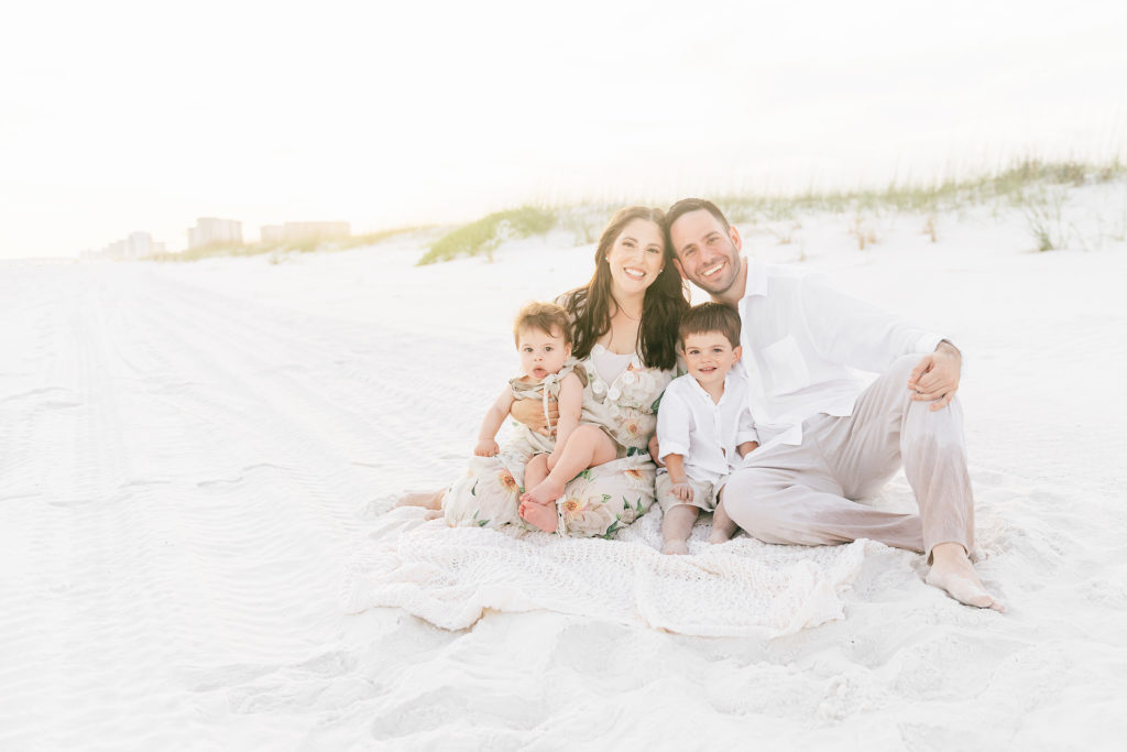 a family posing on the beach for Florida photographer