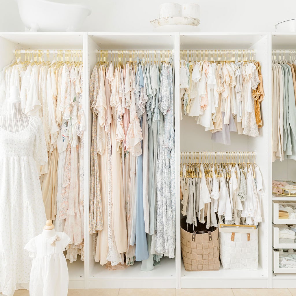 A beautifully curated client closet filled with soft pastel gowns and wraps for newborn and family sessions at Andrea Krey Photography in Niceville FL