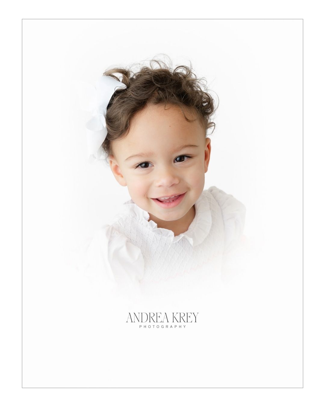 Heirloom portrait gift for grandparents, a smiling toddler girl in a white smocked dress and white hair bow