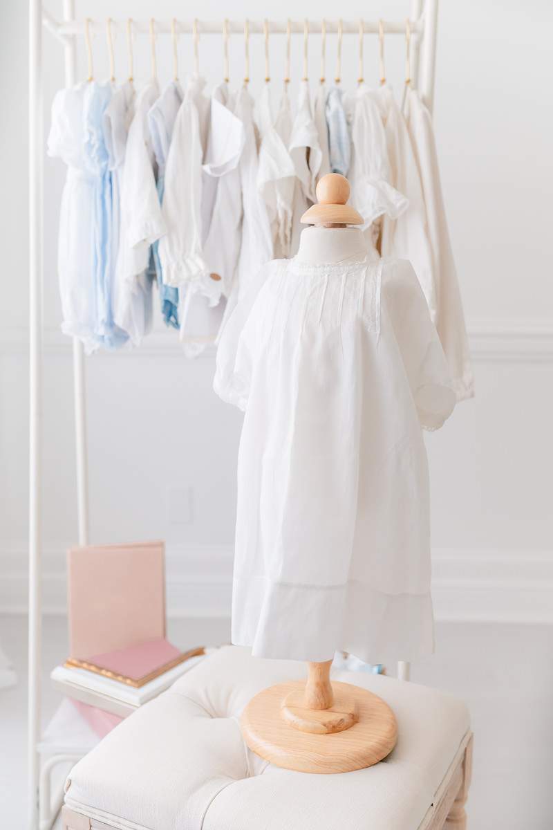 White heirloom christening gown on a mannequin, an outfit idea for a children's portrait gift for grandparents